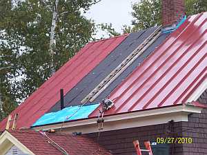 A new metal roof being installed
